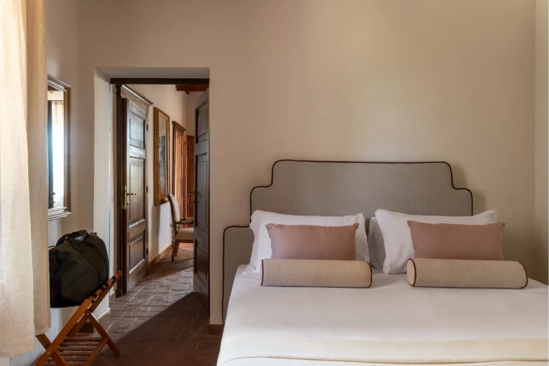 Bedroom at the Villa Annex Adults Only with upholstered headboard and terracotta hallway, 5 minutes from Castello di Leonina - Castello di Leonina, BZAR hotels in Tuscany